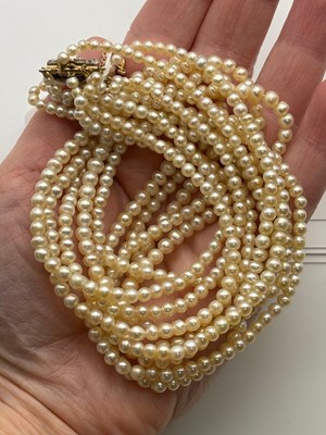 Lot 129 - A multi-strand pearl necklace with diamond set...