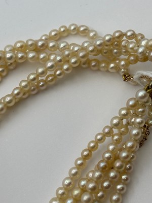 Lot 129 - A multi-strand pearl necklace with diamond set...