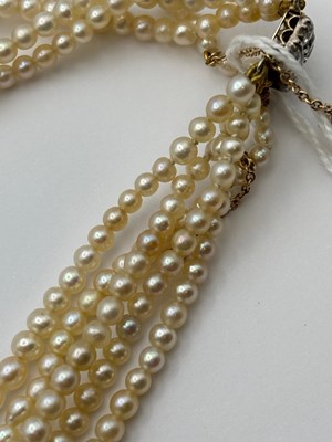 Lot 129 - A multi-strand pearl necklace with diamond set...