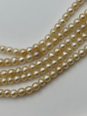 Lot 129 - A multi-strand pearl necklace with diamond set...