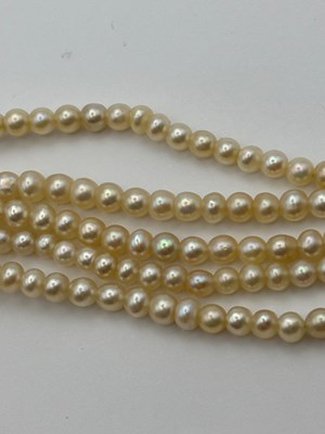 Lot 129 - A multi-strand pearl necklace with diamond set...