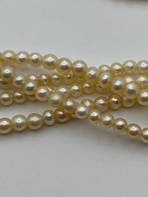 Lot 129 - A multi-strand pearl necklace with diamond set...