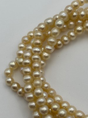 Lot 129 - A multi-strand pearl necklace with diamond set...