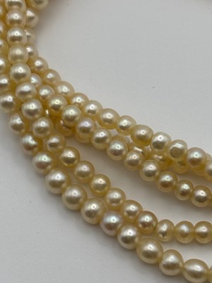 Lot 129 - A multi-strand pearl necklace with diamond set...