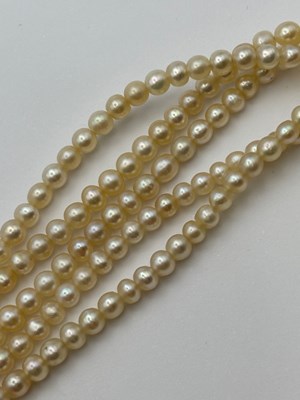 Lot 129 - A multi-strand pearl necklace with diamond set...