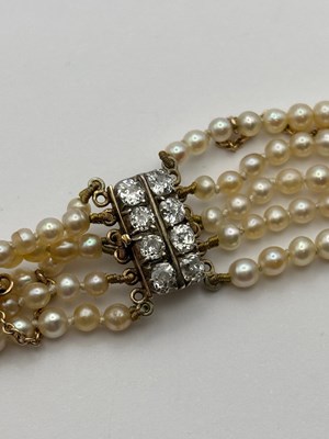 Lot 129 - A multi-strand pearl necklace with diamond set...