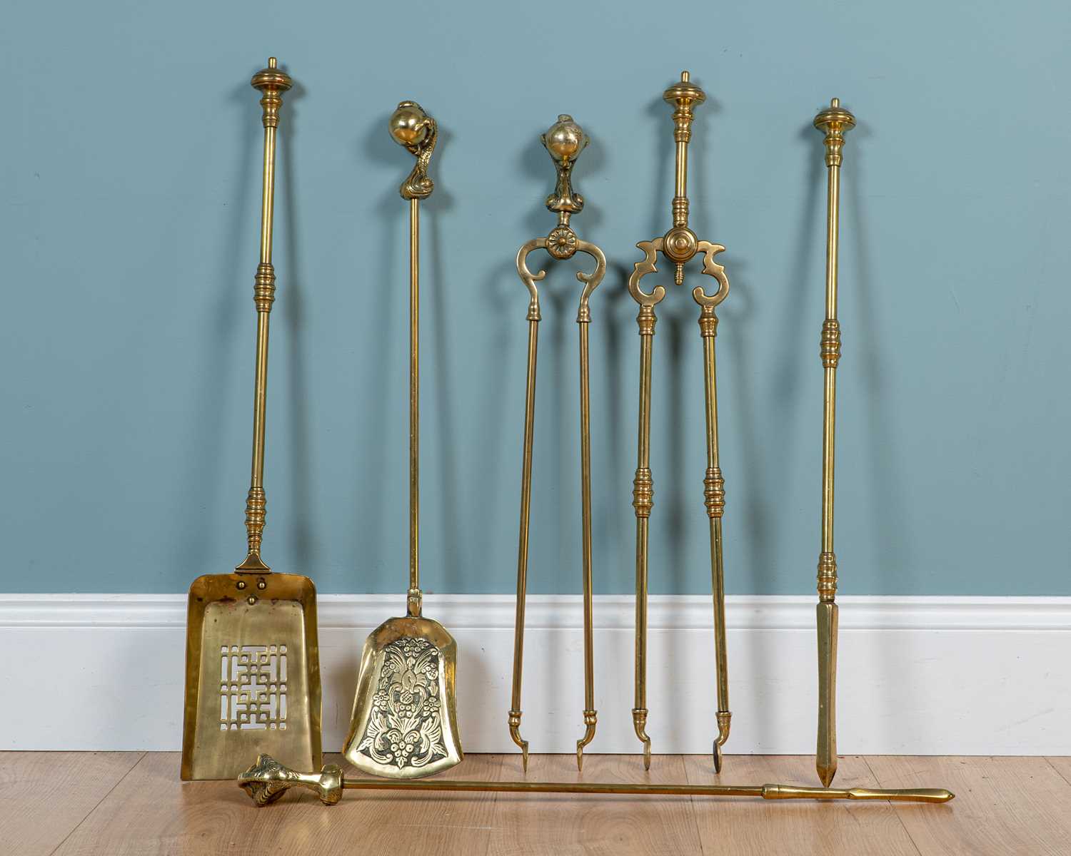 Lot 414 - Two sets of antique brass fire irons