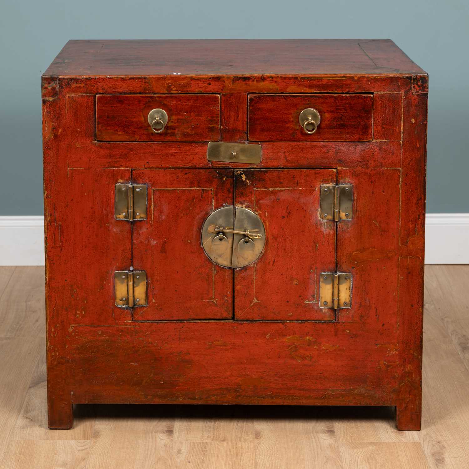 Lot 244 - A Chinese red lacquer side cabinet