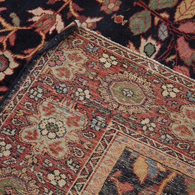 Lot 65 - A Persian blue and red ground rug with a...