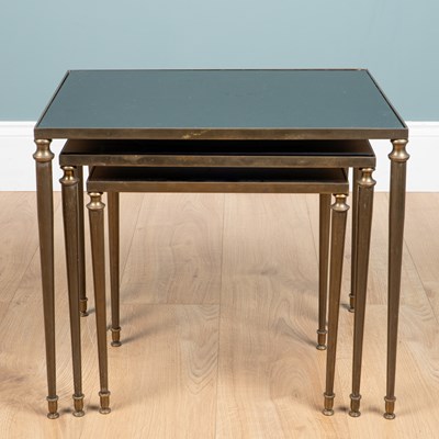 Lot 1070 - A Mid-Century nest of three brass tables