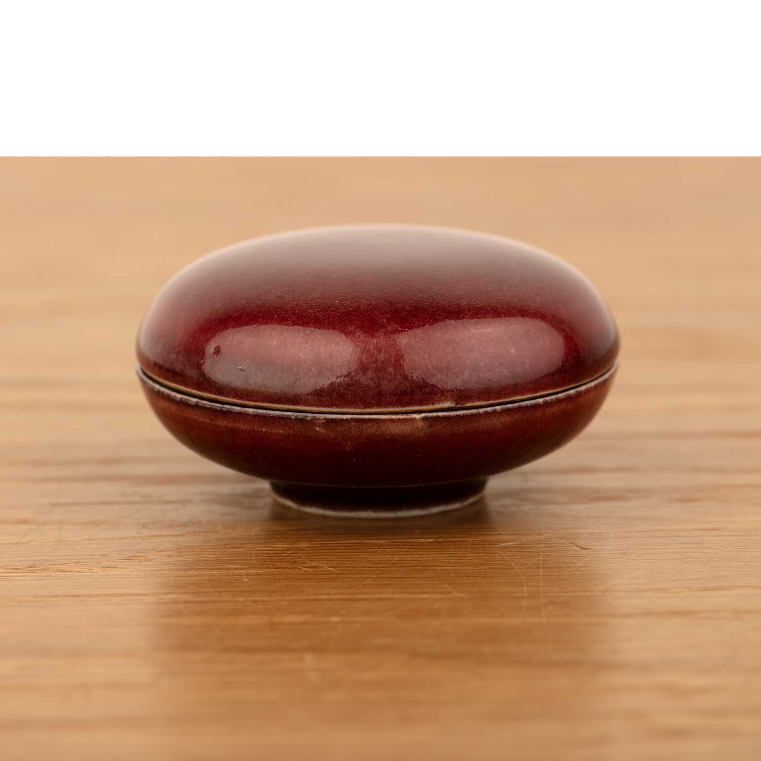 Lot 141 - Copper red glazed circular box and cover...