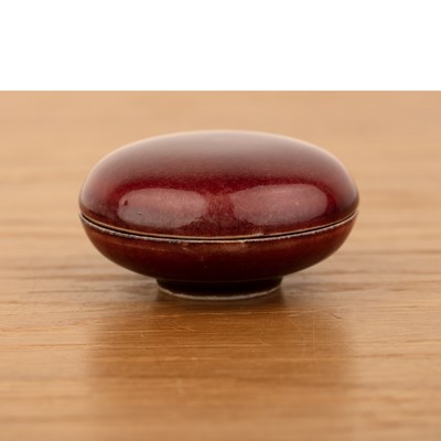 Lot 141 - Copper red glazed circular box and cover...