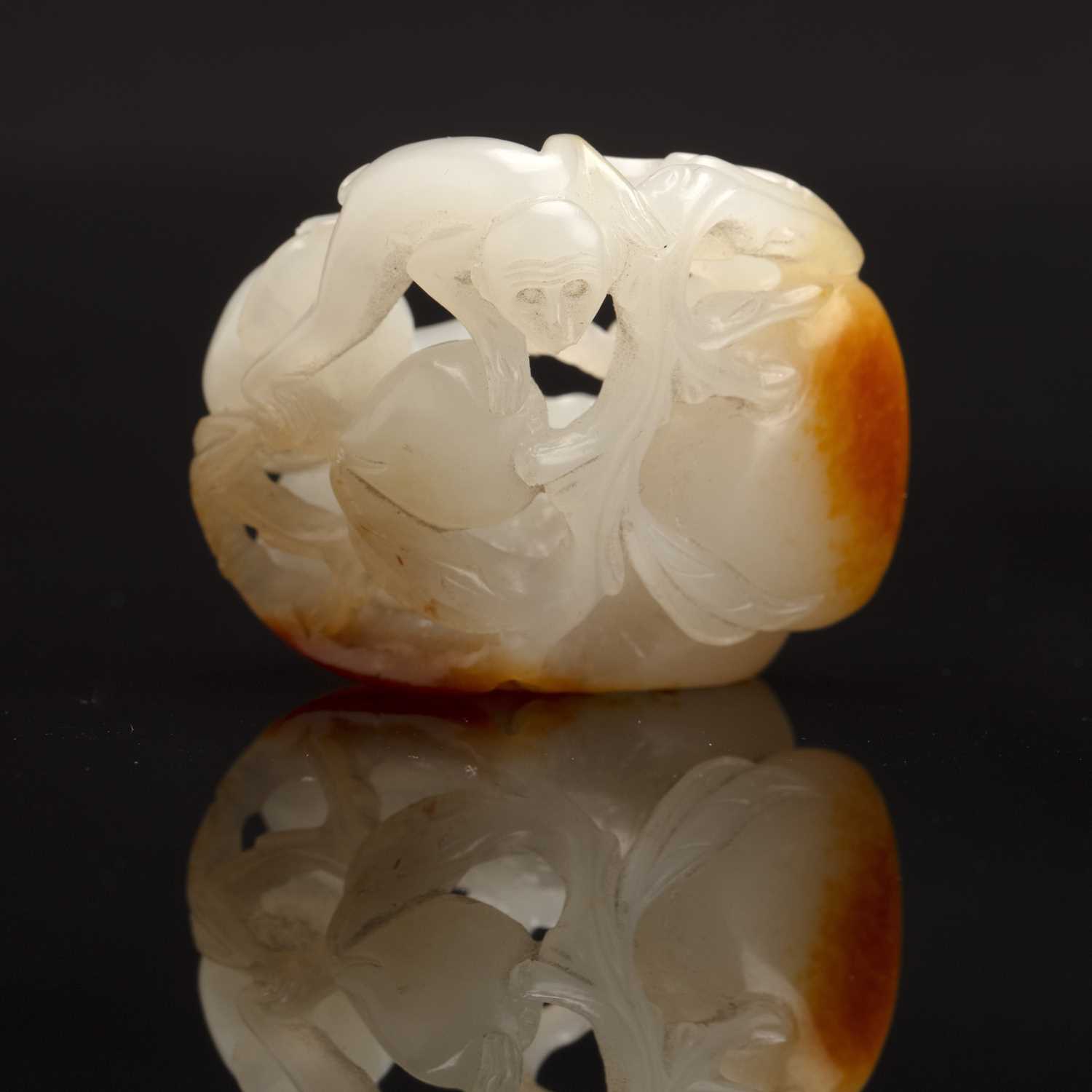 Lot 192 - White and russet jade ‘monkey and peach’ group...