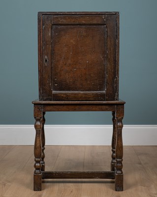 Lot 1138 - An antique oak rustic cupboard on stand