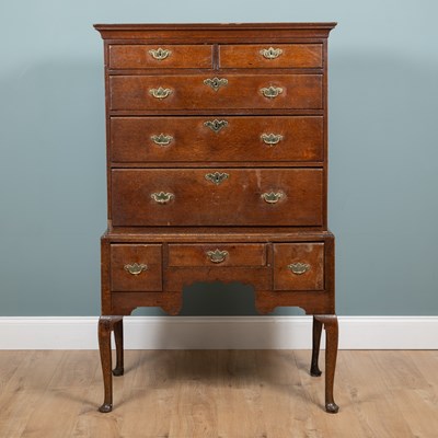 Lot 1070 - A Georgian oak chest on stand