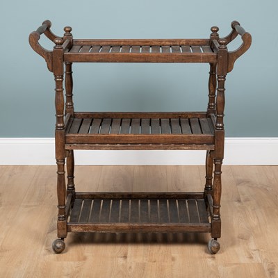 Lot 1199 - An early 20th century oak three-tier trolley