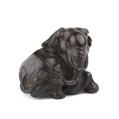 Lot Bronze scroll weight in the form of an...