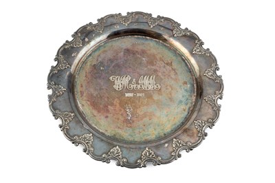 Lot 167 - A George V silver salver, with shaped c-scroll...