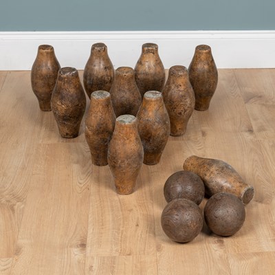 Lot 1053 - A set of eleven turned fruitwood skittles