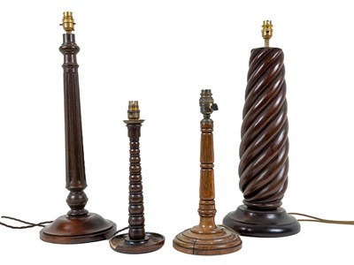 Lot 1154 - A collection of four turned wooden table lamps