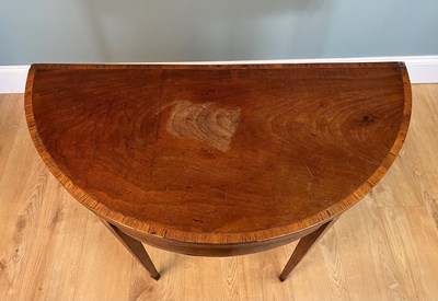 Lot 469 - A Georgian mahogany demi-lune card table