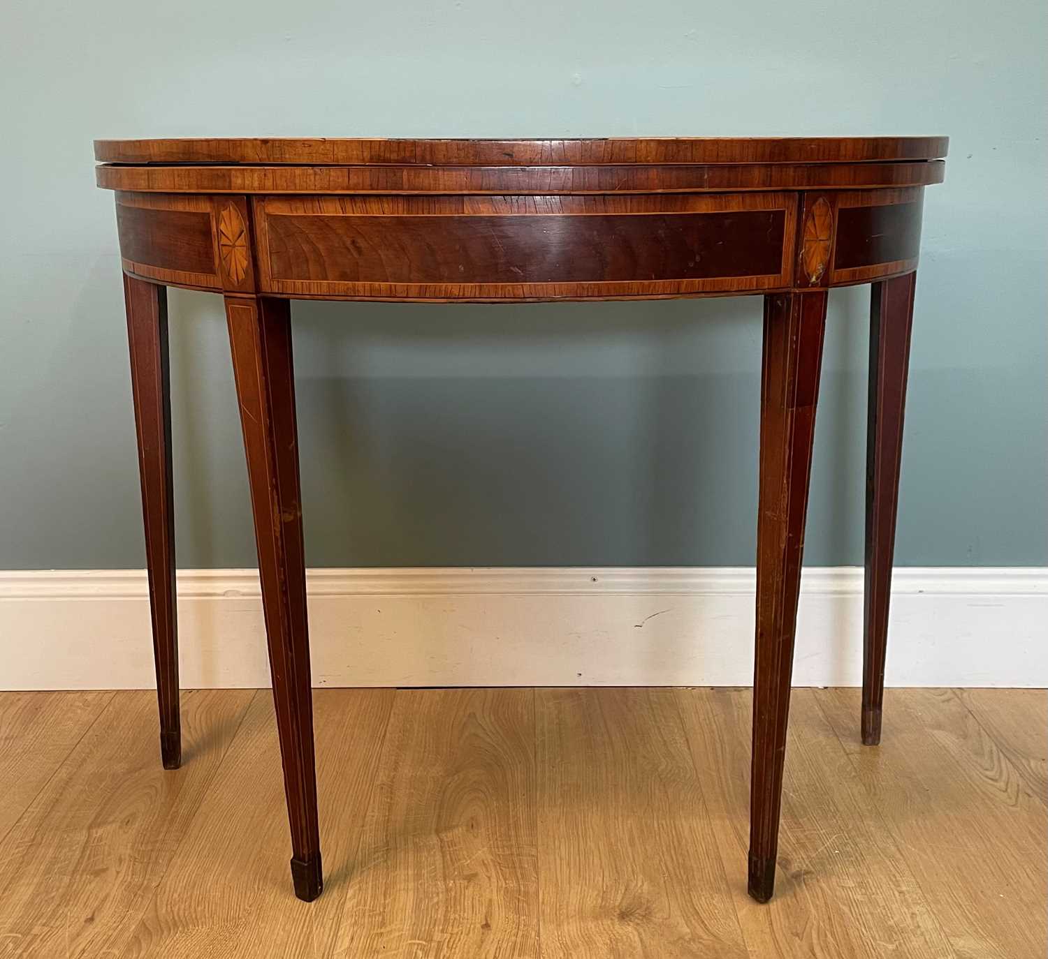 Lot 469 - A Georgian mahogany demi-lune card table