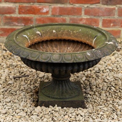 Lot 1388 - A cast iron shallow campana urn