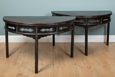 Lot 9 - A pair of Chinese hardwood demi-lune black-laquered console tables