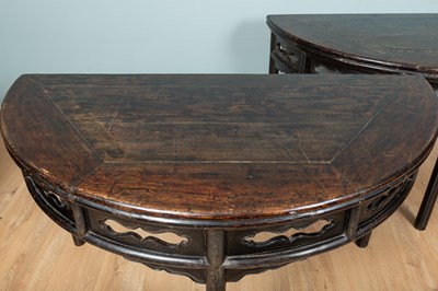 Lot 9 - A pair of Chinese hardwood demi-lune black-laquered console tables