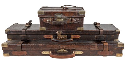 Lot 1211 - Two brass mounted leather shotgun cases together with a cartridge case