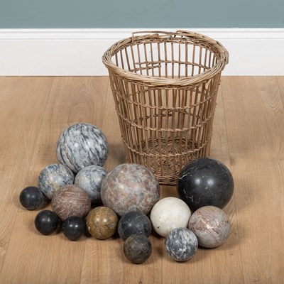 Lot 205 - A wicker basket containing a collection of marble spheres.