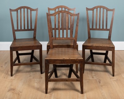 Lot 1005 - A set of four Arts & Crafts oak side chairs