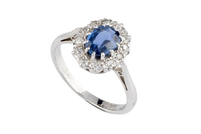 Lot 49 - A sapphire and diamond cluster ring, the oval...