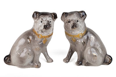 Lot 304 - A pair of French pottery pug dog ornaments