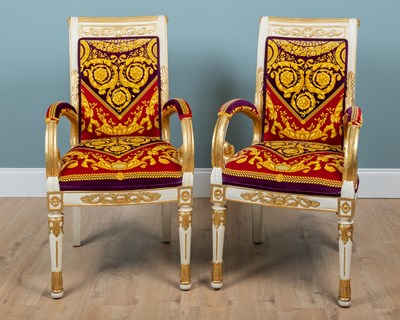 Lot A pair of Atelier Versace Neoclassical-style gilt and white-painted armchairs