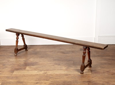 Lot 4 - Rustic oak school-type bench on twin turned...