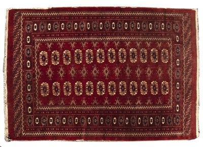 Lot 283 - A middle eastern red ground rug with geometric...