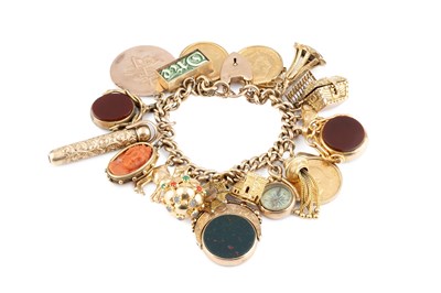 Lot 22 - A charm bracelet, the curb-link bracelet...