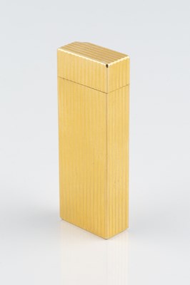 Lot 235 - A gold plated lighter by Cartier, of reeded...
