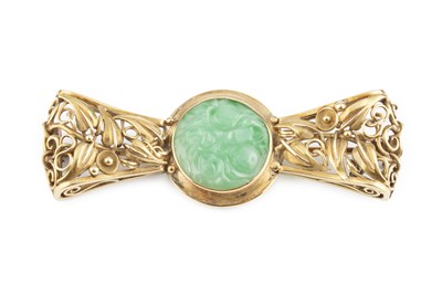 Lot A jade panel brooch, the circular carved...