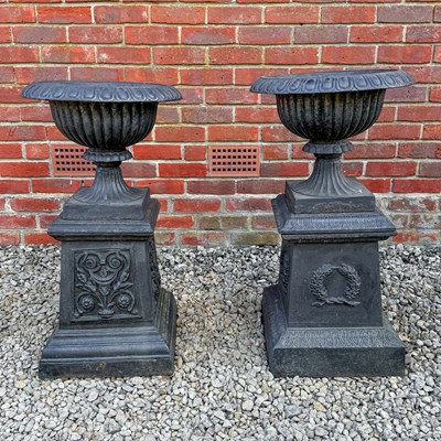Lot 1498 - A pair of old black-painted cast iron shallow campana urns