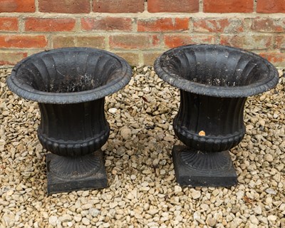 Lot 1325 - A pair of cast iron campana style urns