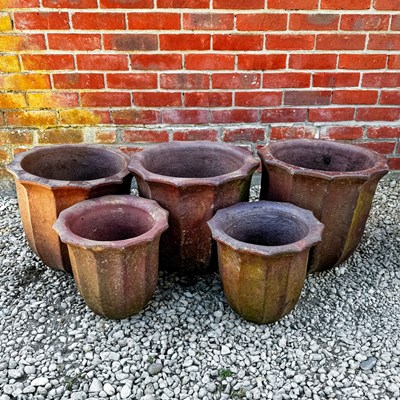 Lot 1432 - A group of five salt glazed stoneware tulip shaped planters