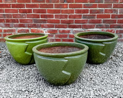 Lot 1379 - A group of three green glazed ceramic planters