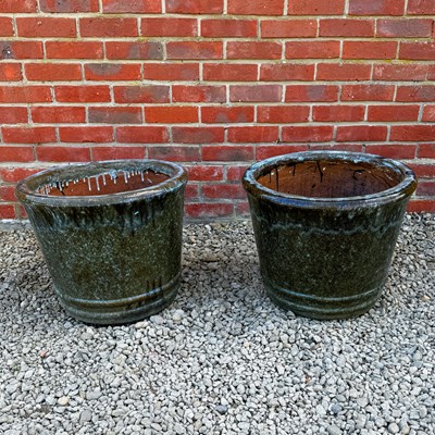 Lot 1411 - A pair of green glazed garden planters