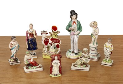 Lot 322 - Group of nine creamware and pottery figures...