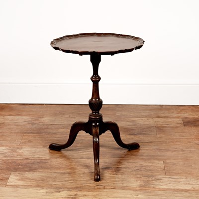 Lot 86 - Mahogany piecrust occasional table on a carved...