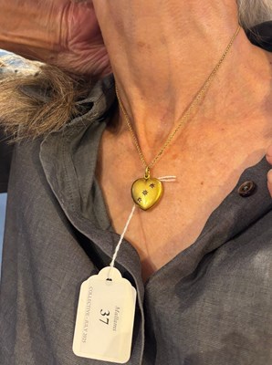 Lot 37 - An Edwardian diamond and stone set locket...