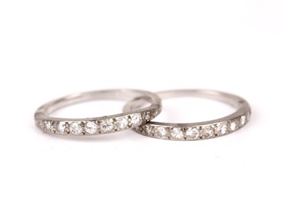 Lot 230 - Two white precious metal half hoop rings...