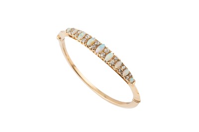Lot 27 - An opal and diamond bangle, of hinged oval...